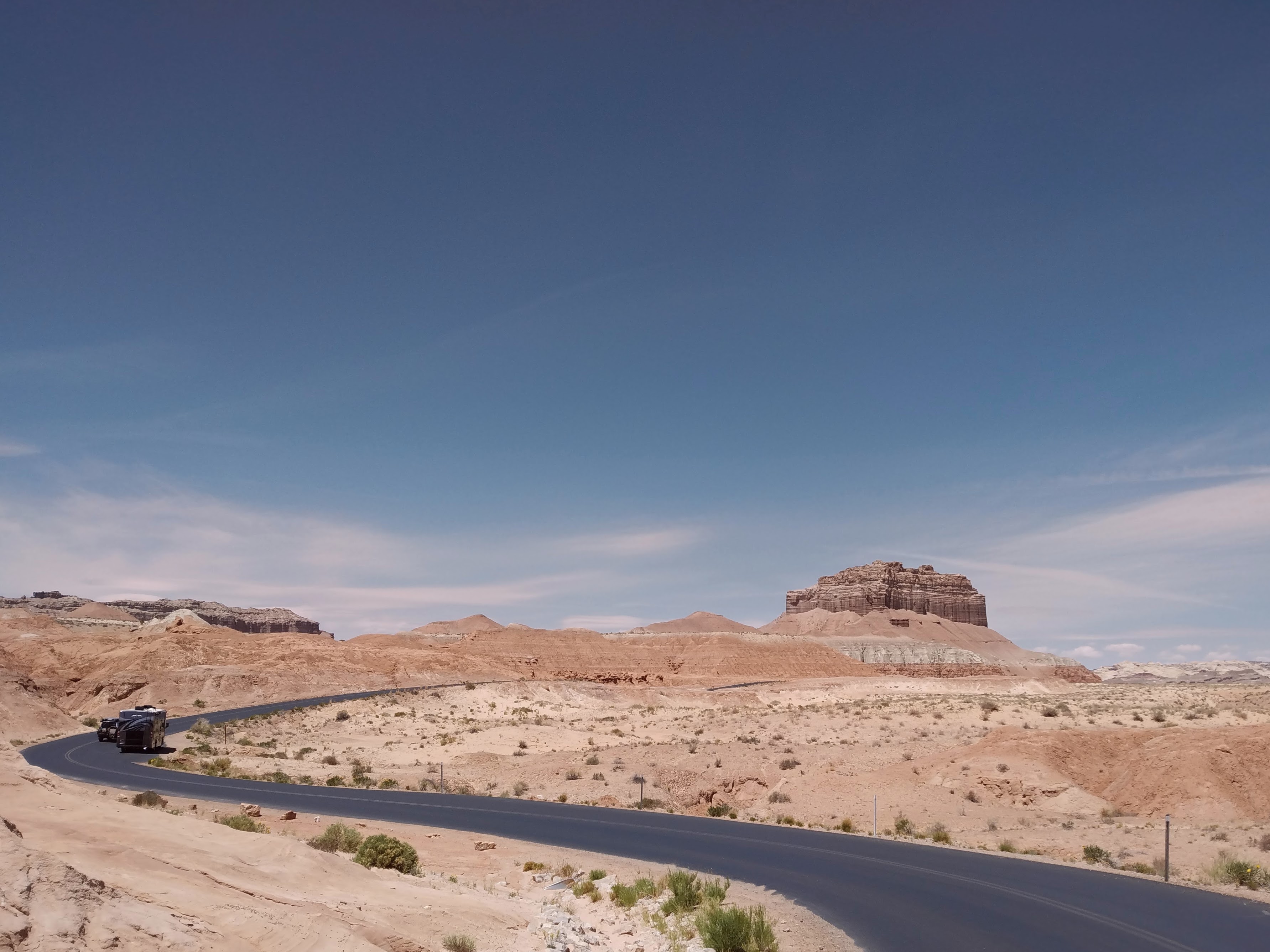 A butte at the end of a twisty road through the desert.