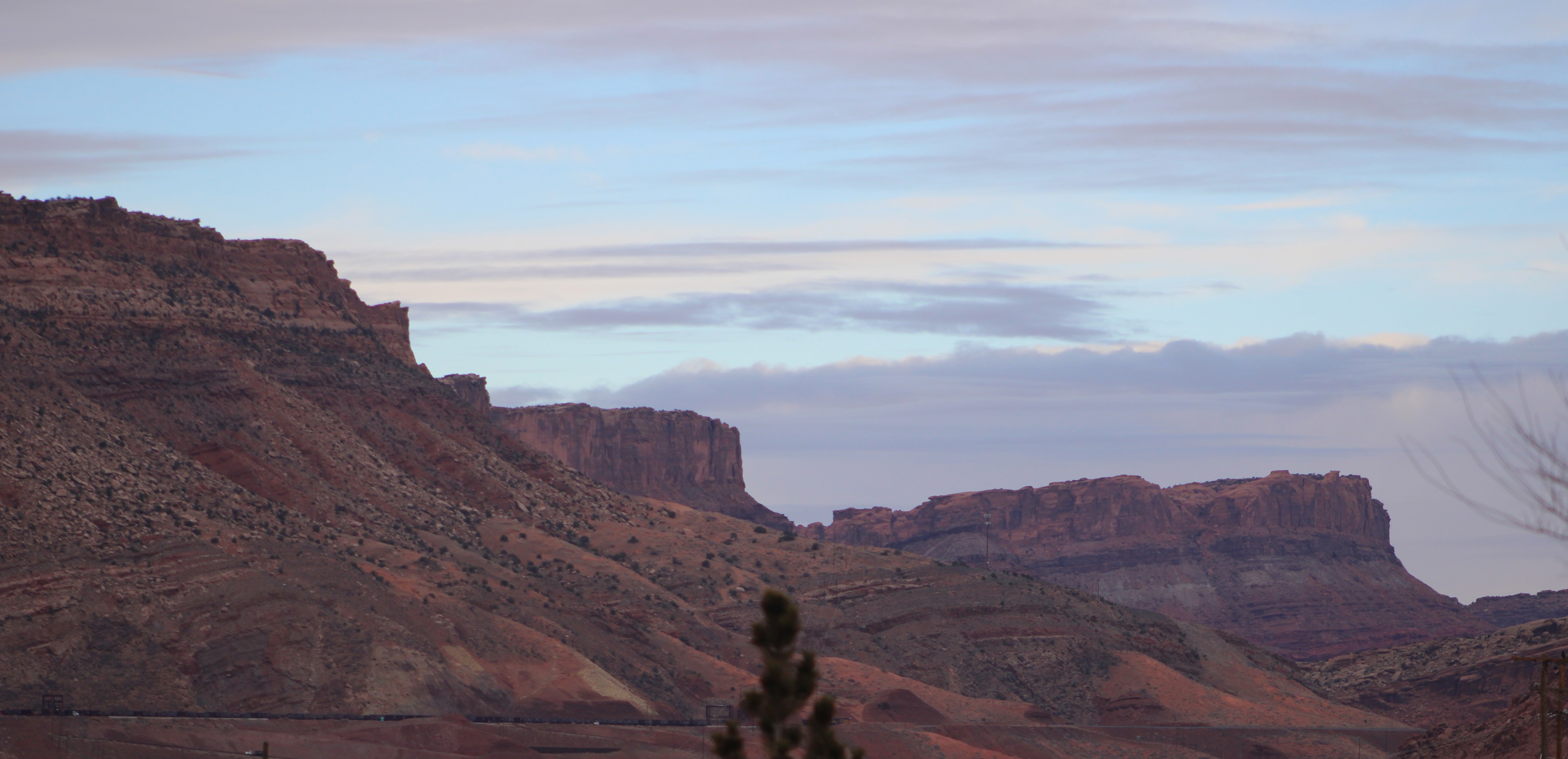 Red rock cliffs along the edge of a canyon.